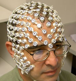 Photo of Dr. Tucker wearing a dense EEG net.
